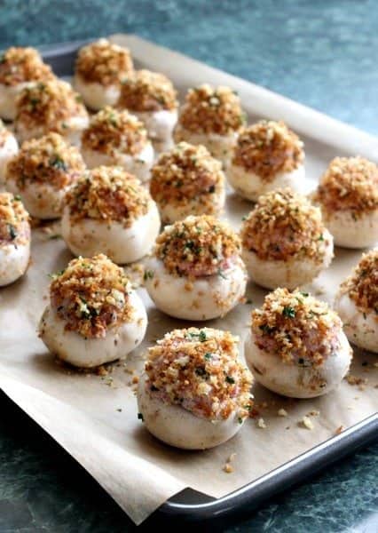 Corned Beef Stuffed Mushrooms are the answer to all your leftover corned beef from St. Patrick's Day. A tasty way to transform leftovers! corned beef stuffed mushrooms on baking sheet