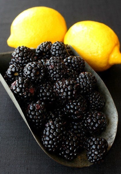 blackberries in a scoop with lemons