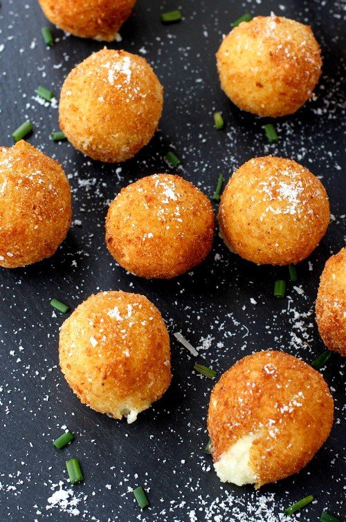 fried mashed potatoes on a black board