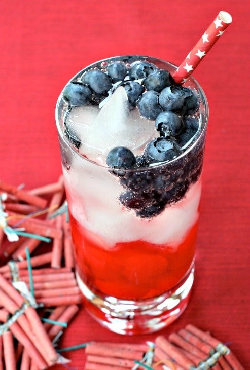cocktail with blueberries and straw