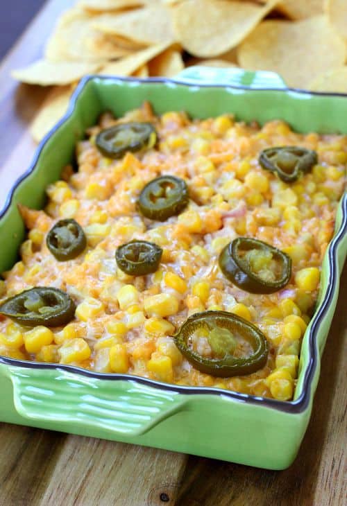 Hot Corn Dip is an easy, cheesy appetizer for parties! You probably have everything you need to make this dip right in your fridge! Cheesy Corn Dip in baking dish