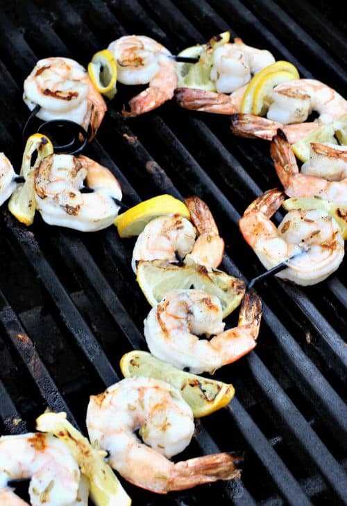 These flavorful Grilled Shrimp Kabobs are on our menu all summer long! Juicy grilled shrimp drizzled with a quick, homemade basil marinade! Pesto Shrimp Kabobs on the grill