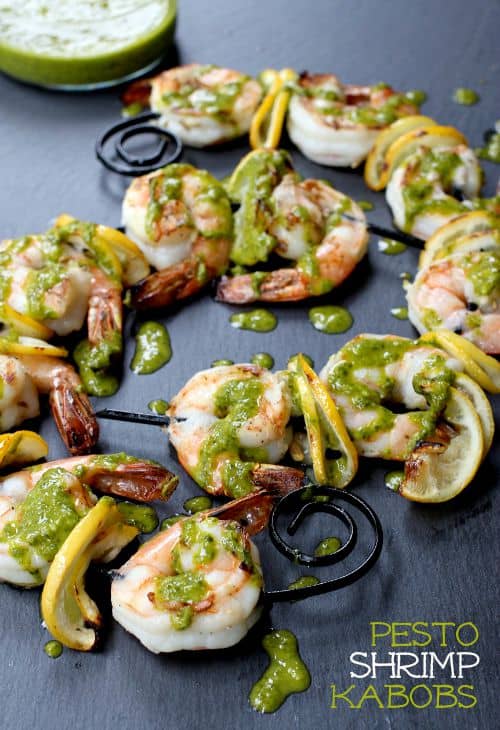 These flavorful Grilled Shrimp Kabobs are on our menu all summer long! Juicy grilled shrimp drizzled with a quick, homemade basil marinade! Pesto Shrimp Kabobs featured