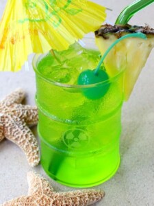 green midori cocktail with umbrella
