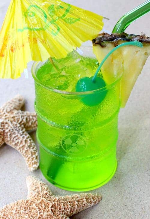 These Pineapple Midori Cocktails are fun, tropical, strong and boozy at the same time! Whip up a few of these drinks at your next party! Toxic Tonic Cocktail with umbrella