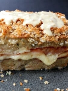 A chicken meatloaf with layers of ham and cheese and a dijon cream sauce