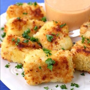 fish nuggets on a plate with sauce