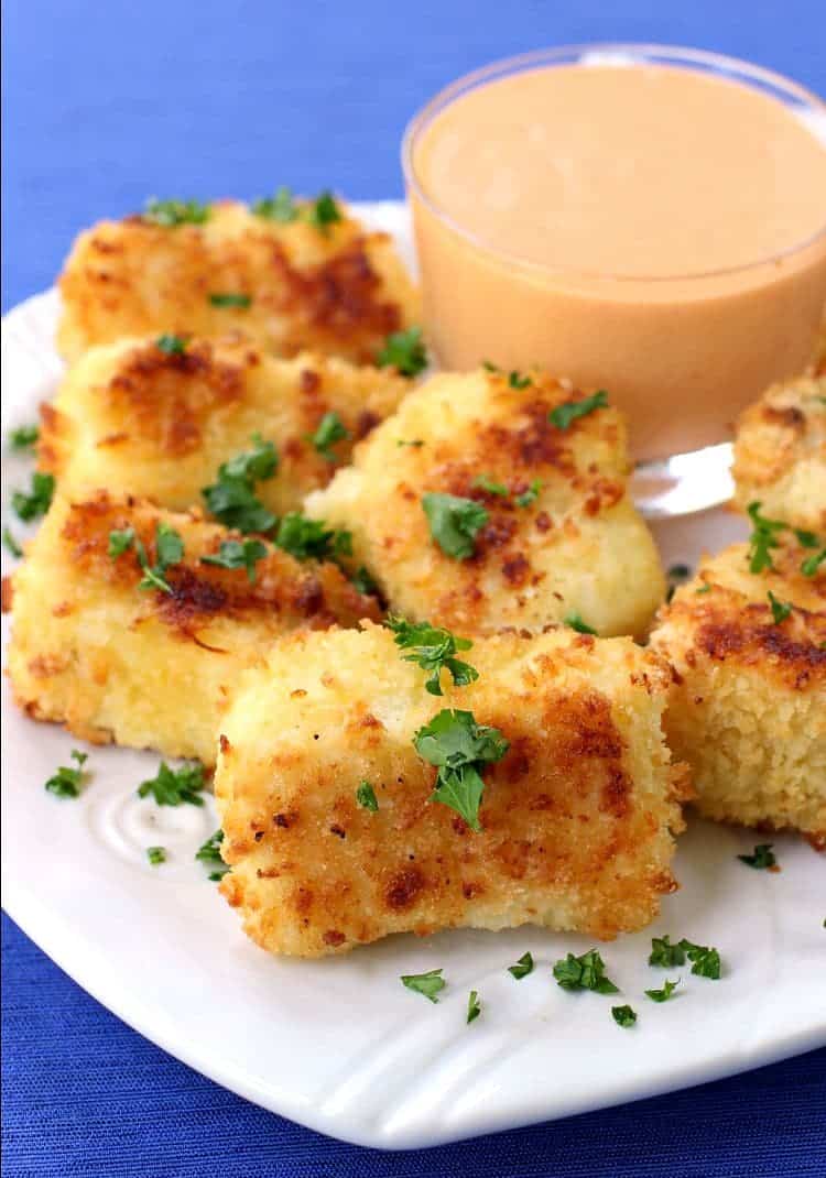 fish nuggets on a plate with sauce