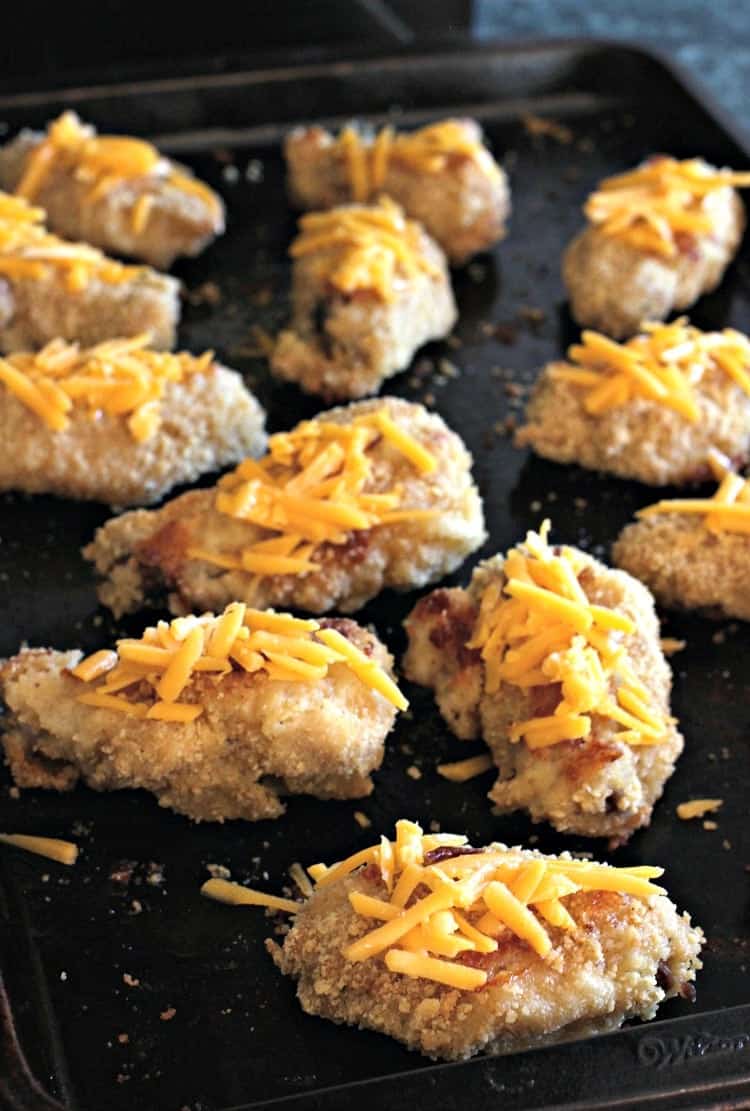 These Nacho Chicken Wings are baked with a tortilla crust and topped with all your favorite nacho toppings! Baked Nacho Chicken Wings Appetizer