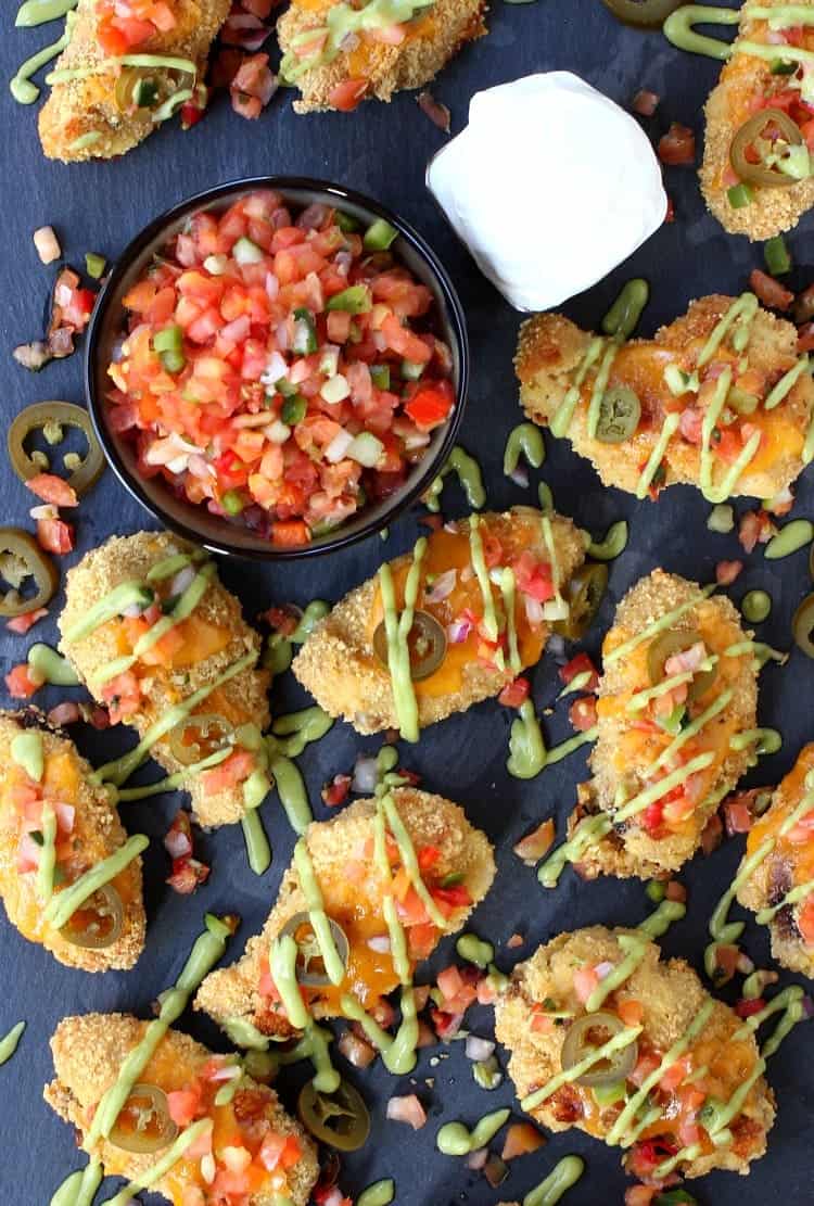These Nacho Chicken Wings are baked with a tortilla crust and topped with all your favorite nacho toppings! Easy Baked Chicken Wings Recipe