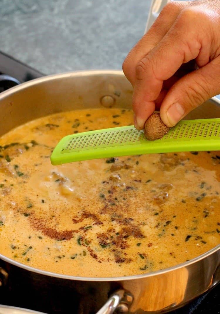 Pasta with Pumpkin Cream Sauce is my kind of fall comfort food! Pasta swimming in a creamy, pumpkin sauce with sausage and fresh herbs! pasta-pumpkin-cream-sauce-grate