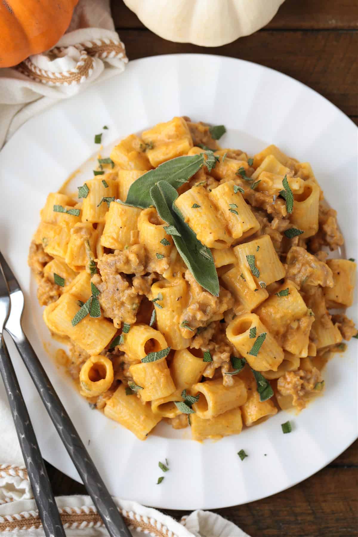 rigatoni in a pumpkin cream sauce with sausage on white plate