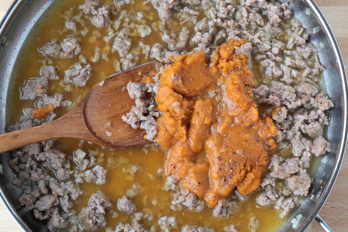 crumbled sausage in a skillet with pumpkin