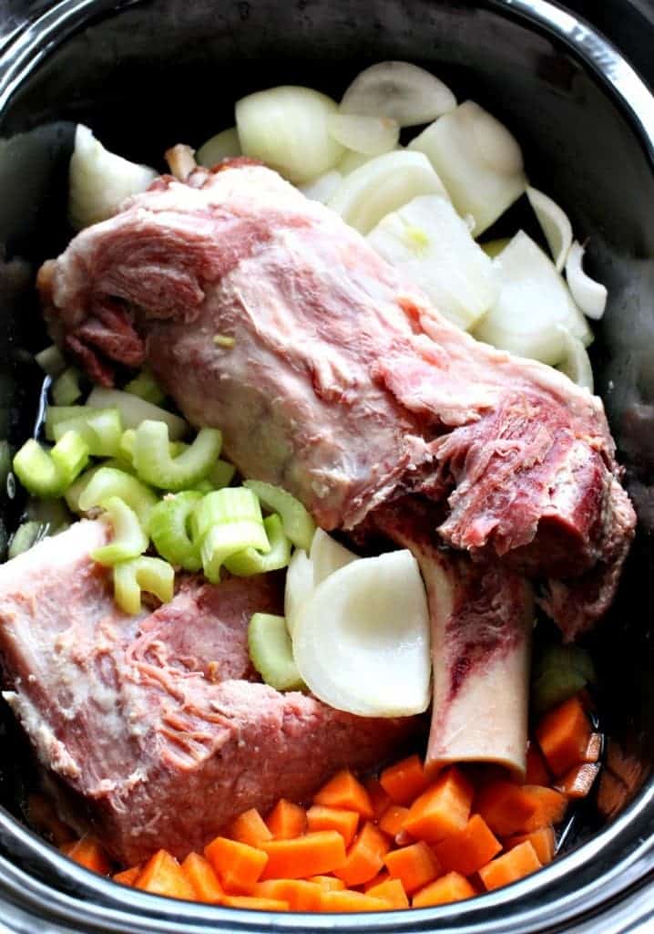 Slow Cooker Ham and Noodle Soup in a slow cooker with ham bone, carrots and onions