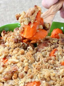 oven roasted carrots with a streusel topping in a green dish
