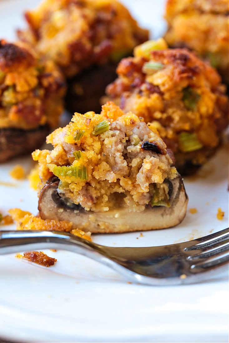 stuffed mushroom cut in half with fork on the side