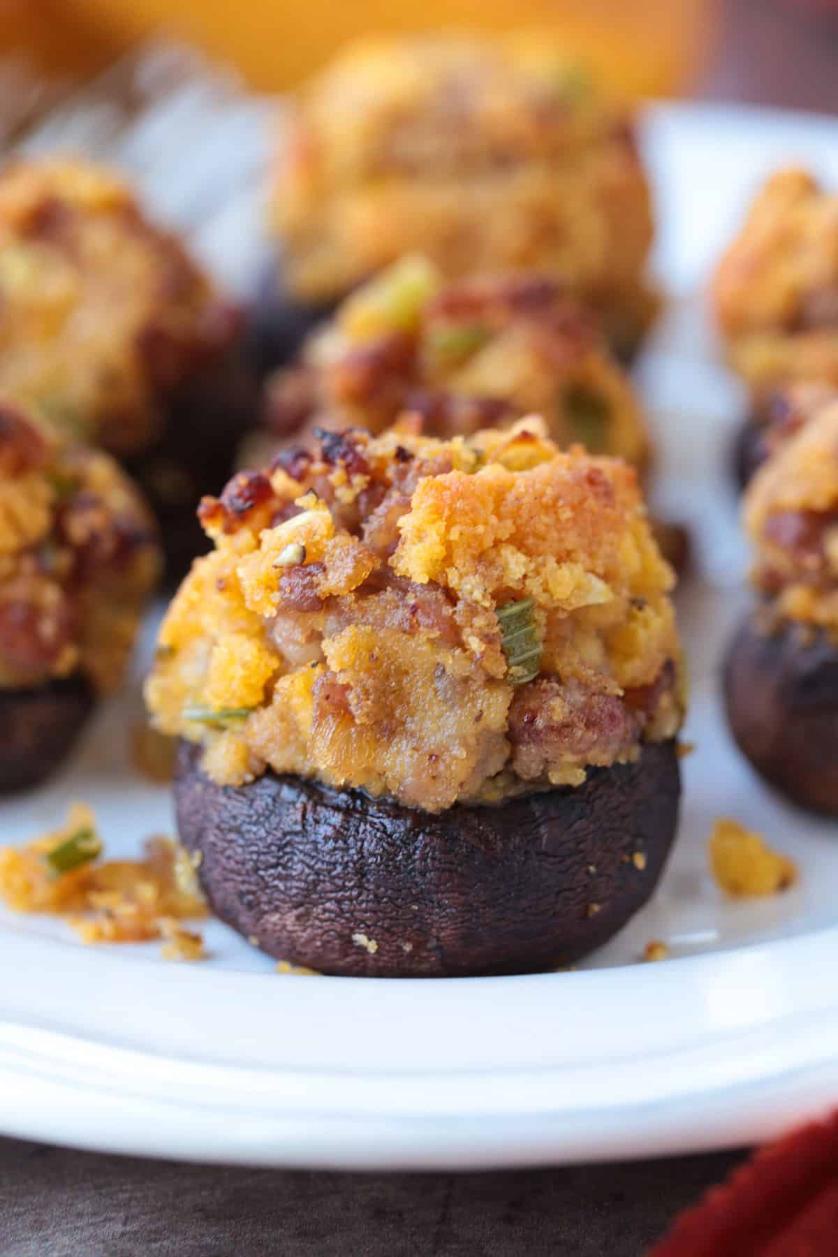 stuffed mushroom with sausage and cornbread on a plate