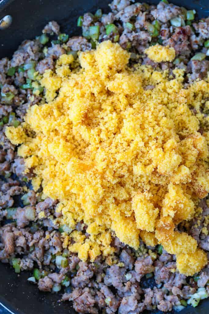 crumbled cornbread in a skillet with sausage
