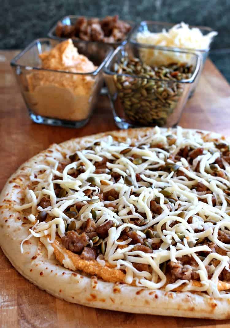 Sausage and Pumpkin Pizza is a festive, fall pizza recipe! Spicy Italian sausage with a creamy pumpkin sauce. Perfect with a glass of wine! spicy-sausage-pumpkin-pizza-toppings