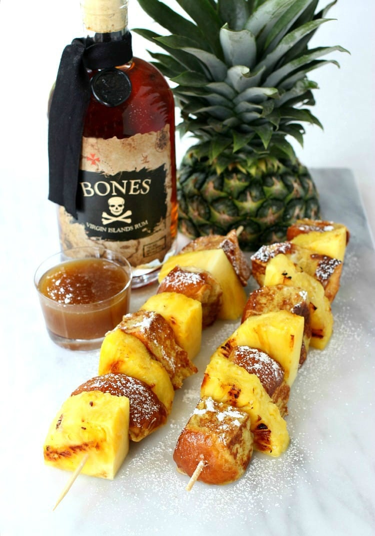 French Toast Kabobs with Butter Rum Syrup on marble