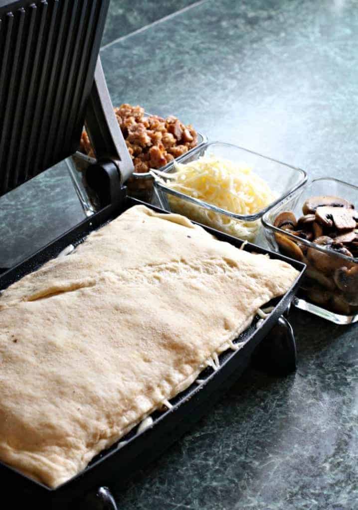 Panini Pizza Sticks are a fun twist on pizza night! Add your favorite pizza toppings or have a pizza toppings bar to customize your own! panini-pizza-sticks-dough
