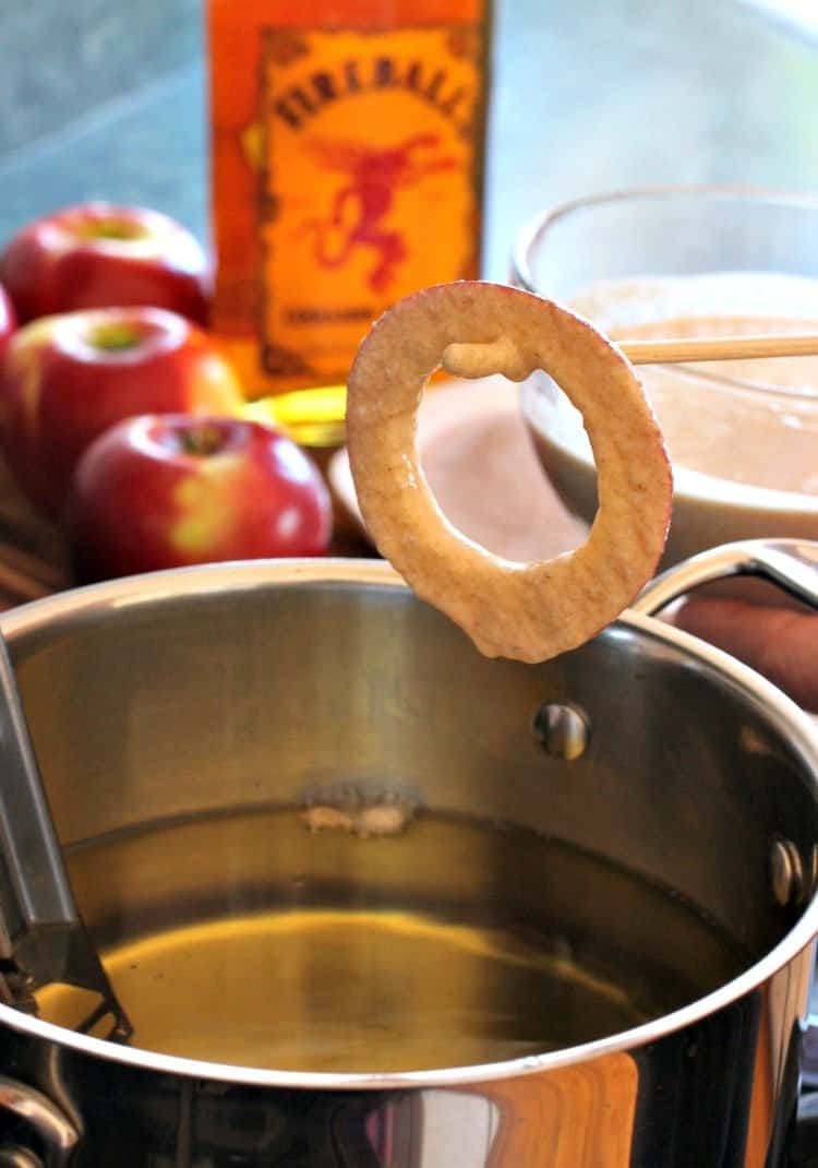 Fireball Apple Fritters are the ultimate party dessert! Fresh apple fritters coated in a cinnamon whiskey batter tossed with cinnamon sugar. fireball-apple-fritters-fry