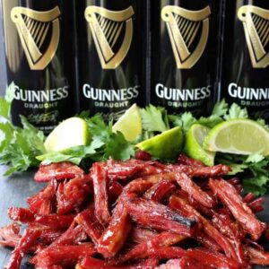 shredded corned beef and sliced limes with beer cans