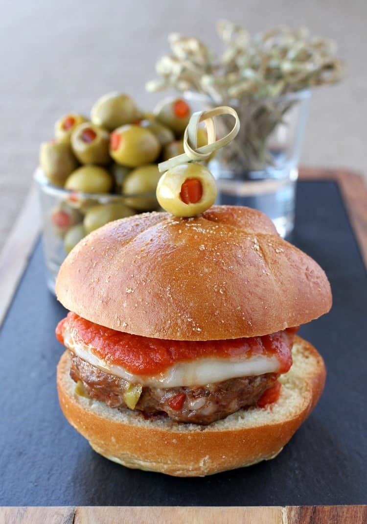 Picadillo Sausage Sliders are a fun and tasty party recipe! Italian sausage patties made with chopped olives and topped with sauce and cheese. sausage-picadillo-sliders-single