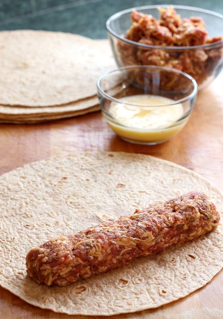 Tex-Mex Sausage Tortilla Rolls will be gone in seconds at your next party! A cheesy sausage roll filling wrapped in a crispy tortilla shell! tex-mex-sausage-tortilla-roll-process