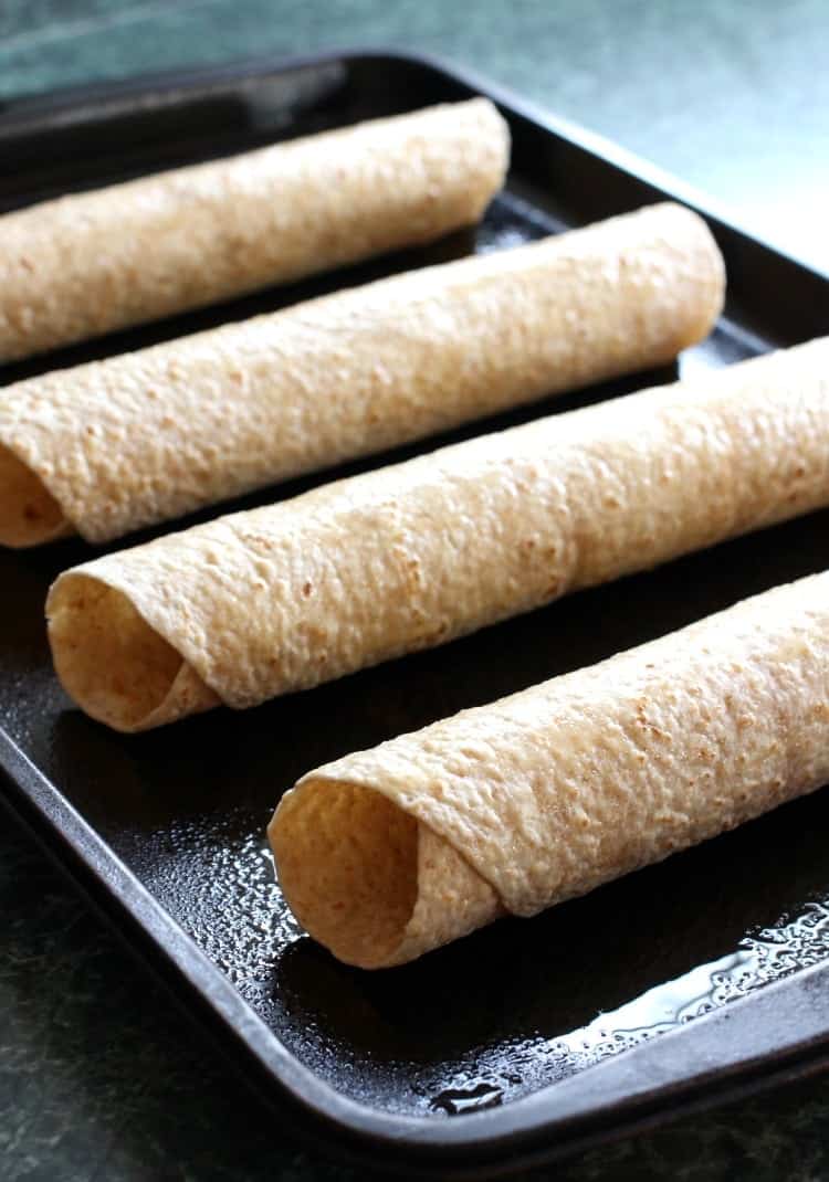 Tex-Mex Sausage Tortilla Rolls will be gone in seconds at your next party! A cheesy sausage roll filling wrapped in a crispy tortilla shell! tex-mex-sausage-tortilla-rolls-oven