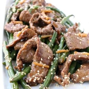 Ginger Beef and green bean stir fry on a white plate