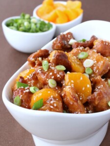 orange chicken in a white serving bowl