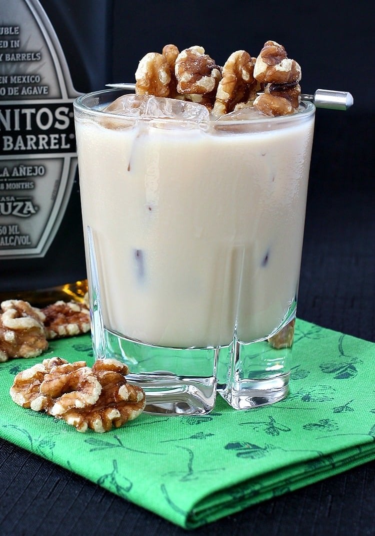 Nutty Tequila Cocktail in a glass with walnut garnish