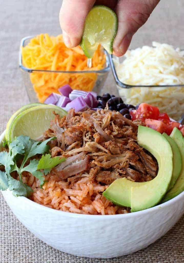 Shredded Pork Taco Bowls with cheese and a lime squeeze