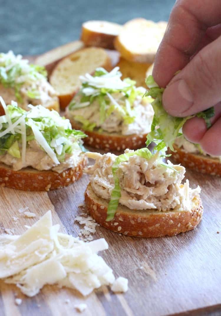 This Chicken Caesar Bruschetta is perfect for appetizers, snacks, or even a light dinner! This chicken salad is so delicious, even on it's own! Caesar Chicken Salad Bruschetta is a chicken salad recipe that's topped with lettuce and parmesan cheese