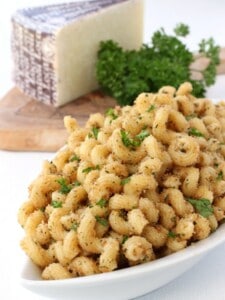 garlic bread pasta in a dish with parmesan cheese