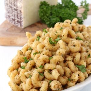 garlic bread pasta in a dish with parmesan cheese