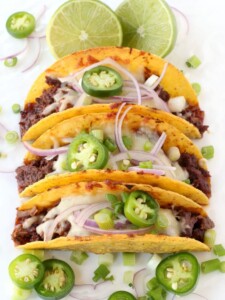 korean beef tacos on a platter with toppings