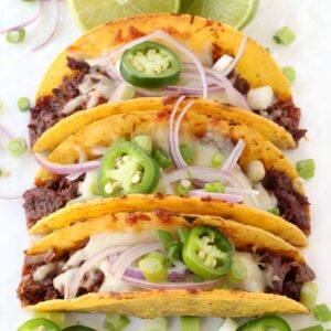 korean beef tacos on a platter with toppings