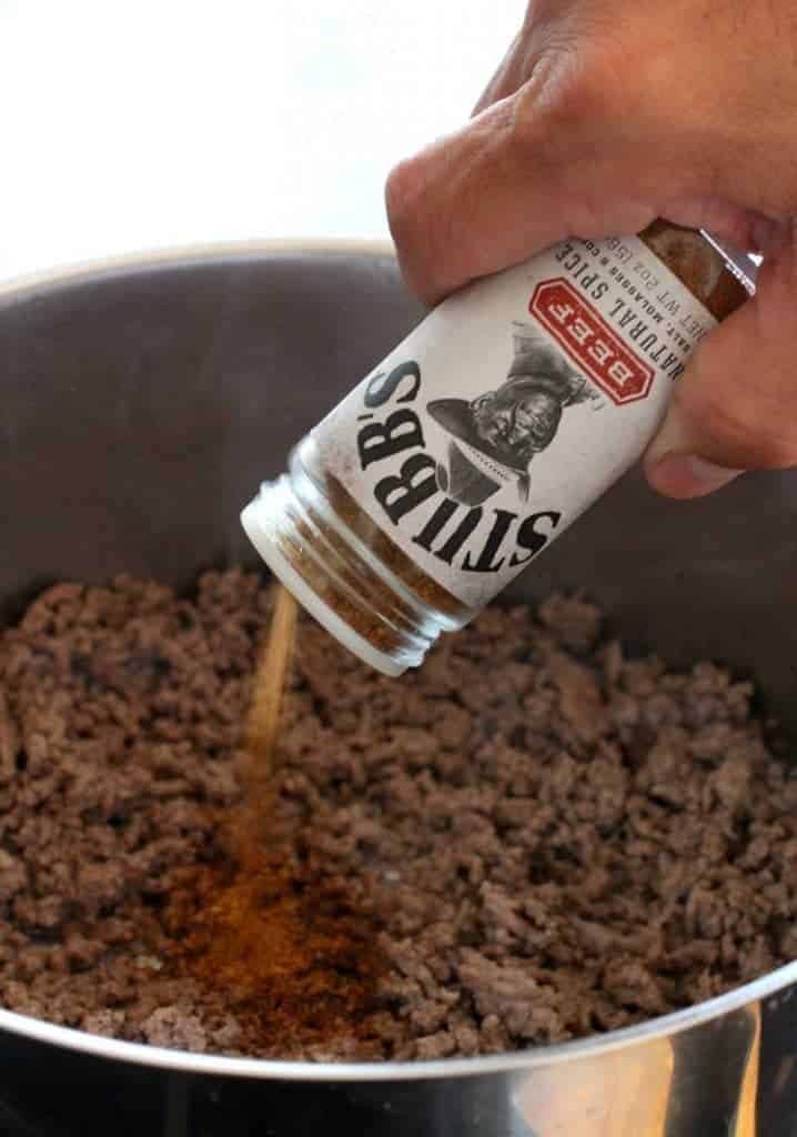 Ground beef being seasoned to make cheeseburger & potato chowder