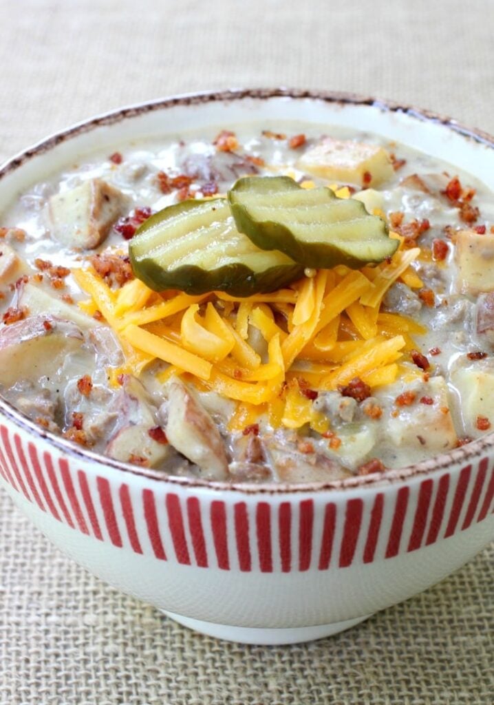 Cheeseburger and Fries Chowder topped with pickles and cheese