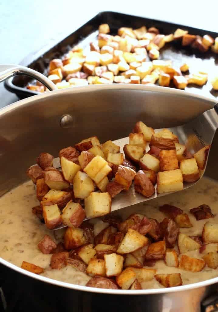 Roasted potatoes going into a potato chowder recipe