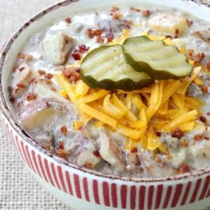 cheeseburger chowder recipe in a bowl with pickles