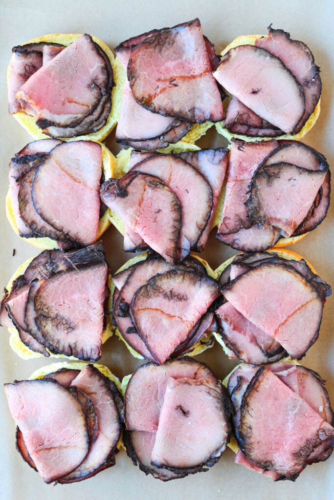 Our French Dip Sliders have a secret sauce that sets them apart from the rest. Beefy, cheesy comfort food perfect for parties and game days! open faced sliders with roast beef and cheese