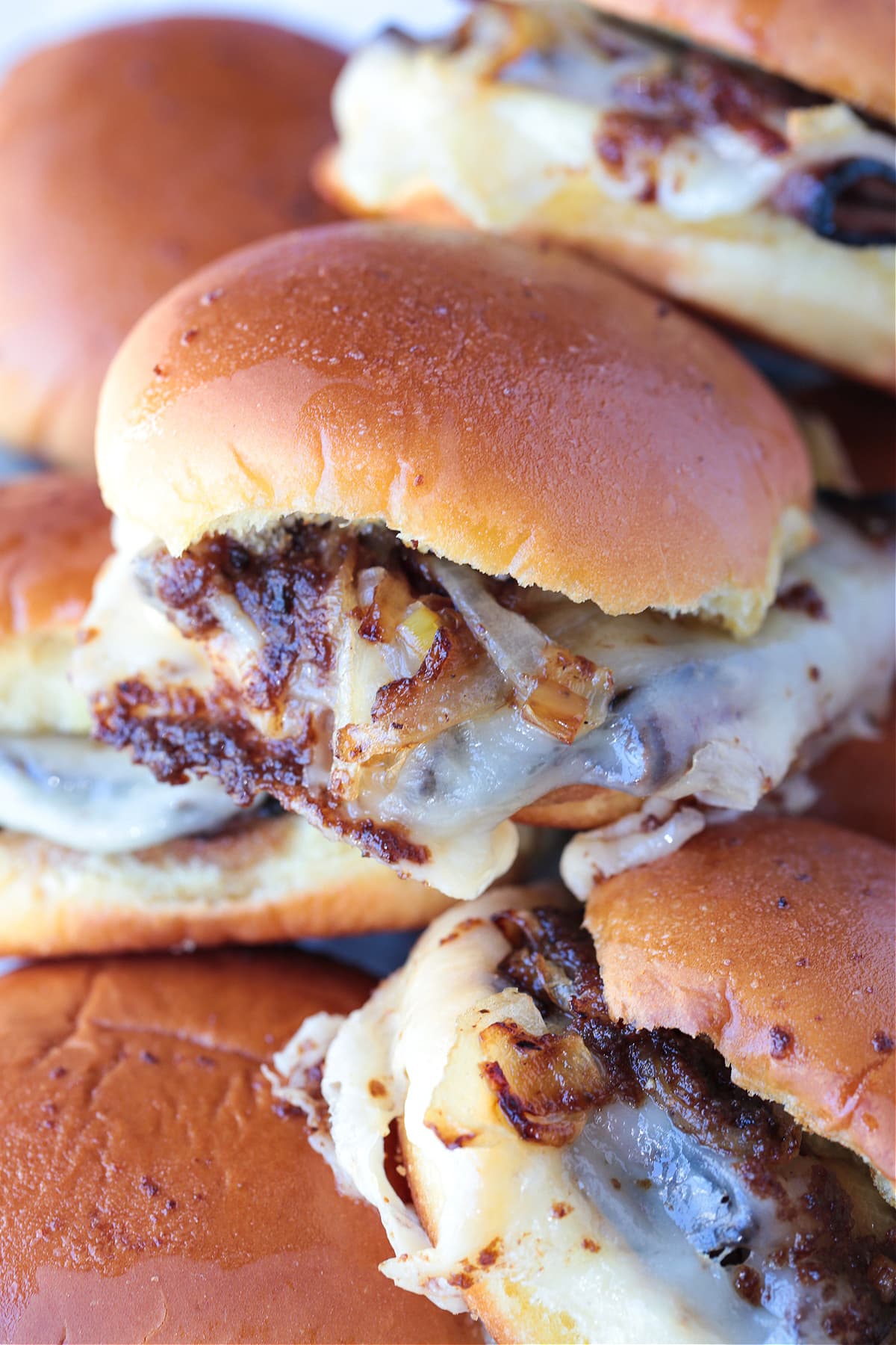 Our French Dip Sliders have a secret sauce that sets them apart from the rest. Beefy, cheesy comfort food perfect for parties and game days! french dip sliders stacked