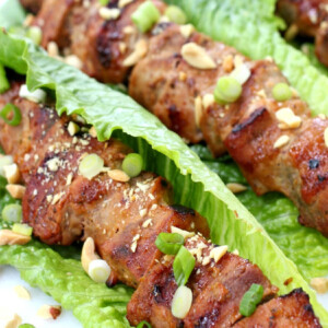 close up of pork kabobs in lettuce leaves
