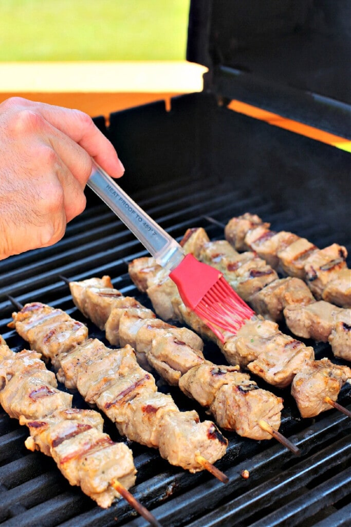 Thai Pork Kabobs have the most delicious sweet and nutty flavor! Wrap in lettuce for easy removal from the skewers and serve with rice! basting pork kabobs on the grill