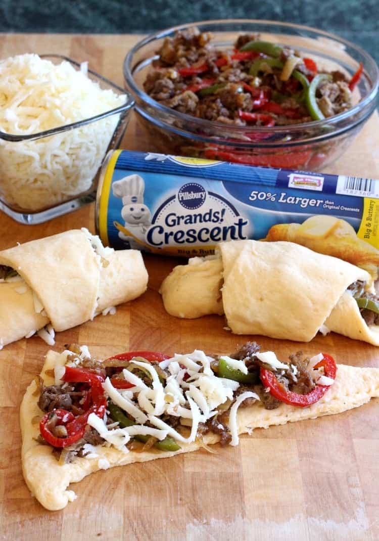 These Philly Cheesesteak Crescent Rolls are loaded with beef, peppers, onions and cheese. Perfect for appetizers or a fun dinner! philly-cheesesteak-crescent-rolls-board