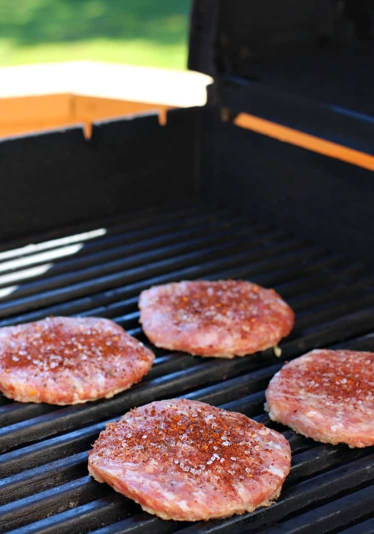 Grab the napkins for this crazy tasty Bang Bang Burger! This pork burger is actually dipped into Bang Bang Sauce before adding to a bun! BBQ Bang Bang Burger pork patties on the grill