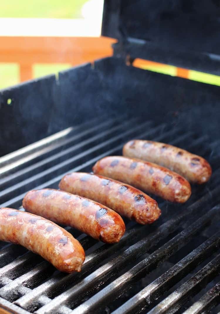 Bratwurst with Pineapple Tequila Salsa are boiled in beer and onions and then finished on the grill